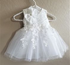 White Lace Dress With Lace Bodice For Ceremonies, White Sleeveless Lace Baptism Dress, White Sleeveless First Communion Dress With Lace Bodice, White Sleeveless First Communion Dress With Lace Trim, Sleeveless Lace Bodice Dress For Baptism, Sleeveless White Lace Baptism Dress, White Lace Bodice Dress For Confirmation, Sleeveless Lace Dress With Lace Bodice For Baptism, White Sleeveless Dress For Ceremony