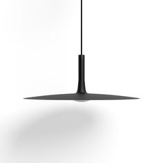 a black light hanging from the ceiling on a white background with shadow and lighting bulb