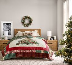 a bedroom decorated for christmas with wreath on the wall