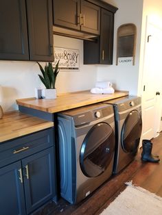 a washer and dryer sitting in a kitchen next to each other on top of a wooden counter