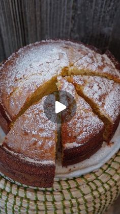 a cake sitting on top of a basket covered in powdered sugar