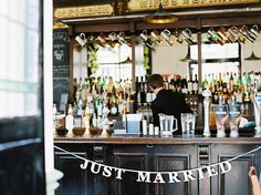 the bar is decorated with just married banners