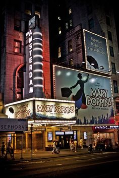 the marquee for mary poppins is lit up at night