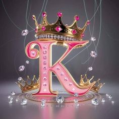 the letter k is decorated with pink and gold crowns