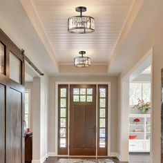 an entryway with two doors and a rug on the floor in front of it