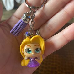 there is a little doll keychain in the hand