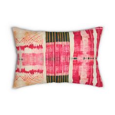 a red and white pillow with an abstract design on the front, in different colors