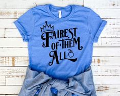 a blue shirt with the words fairest of them all printed on it