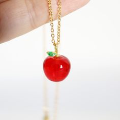 "Beautiful and lovely red apple necklace made of red apple charm with skinny gold plated brass chain. A simple and cute-looking dainty necklace is good for yourself or gift! Your necklace will ship in a gift box. ♥Chain length 15\" - 22\"  ♥Apple Charm 1/2\" x 5/8\"  ♥Resin charm and Gold plated brass chain ♥ Delivery Time Fast shipping within 1 - 3 days  ♥  See more Rudiana Accessories  Rudiana.etsy.com" Cute Red Charm Necklaces For Gifts, Cute Red Charm Necklace For Gift, Elegant Red Charm Necklace For Gift, Elegant Red Charm Necklace, Princess Behavior, Red Novelty Jewelry With Charms, Apple Pendant Necklace, Apple Jewelry, Apple Necklace