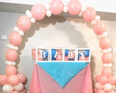 a baby shower table with balloons and decorations