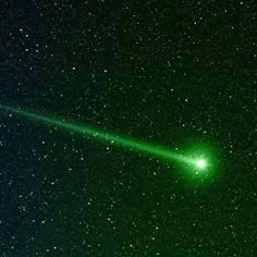 a bright green light shining in the dark sky with stars on either side and behind it