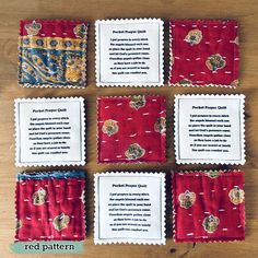 four pieces of red and white fabric with different designs on them sitting on top of a wooden table