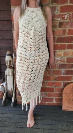 Hand crochet from 100% cream cotton / slight lemon tint . Size 8 but will fit a small 10. Model in photo is size  8-10 . Dress is calf length with Fringing. Small button on back to do up. Scooped at front so slightly shorter at back.  Can be worn with a slip,  wear over swimwear or be brave and show off you summer body over your favourite knickers. Dress is handmade . White Sleeveless Crochet Lace Maxi Dress, White Bohemian Crochet Maxi Dress, Summer Beige Long Crochet Dress, Beige Long Crochet Dress For Summer, Cream Sleeveless Crochet Dress For The Beach, Cream Sleeveless Crochet Dress For Beach, Cream Sleeveless Crochet Dress For Vacation, Beige Crochet Maxi Dress For Beach, Sleeveless Cream Crochet Dress For Beach