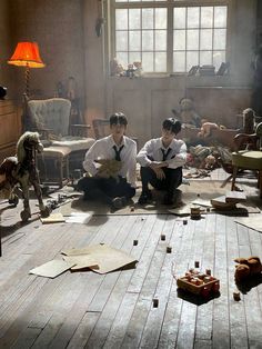 two men sitting on the floor in an old room