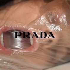 an open mouth with the word prada in front of it