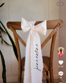 a chair with a white bow tied to it's back and the words reserved written on it