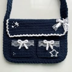 a crocheted purse with white lace and bows