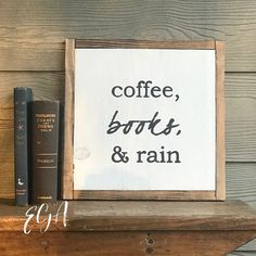 a sign that says coffee, books, and rain next to some books on a shelf