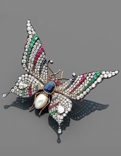 René LALIQUE | An antique gold and multi-gem en tremblant butterfly brooch, circa 1890. Designed as a butterfly, with spring-mounted wings set with brilliant-cut diamonds, rubies, sapphires and emeralds, the body set with a large oval sapphire and a natural pearl, mounted in yellow gold and silver. Gem Butterfly, Spider Jewelry, Fish Jewelry, Dragonfly Jewelry, Bee Jewelry, Insect Jewelry