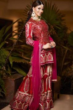 Red kurta with Mughal, floral embroidered motifs. Paired with embroidered sharara and sheer dupatta. Bridal Gharara Designs, Bride Images, Ramadan Outfit, Bridal Gharara, Rimple And Harpreet Narula, Gharara Designs, V Neck Kurta, Silk Kurta Set, Embroidered Sharara