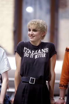 a woman with blonde hair wearing a black shirt