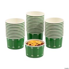 green and white paper cups with footballs printed on them, one is filled with macaroni and cheese