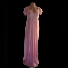 a pink dress is displayed on a mannequin