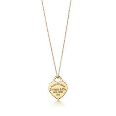 Inspired by the iconic key ring first introduced in 1969, the Return to Tiffany collection is a classic reinvented. This design's simple yet elegant aesthetic effortlessly exudes modern grace. 18k gold; Size small, on an 18'' chain | Return to Tiffany® Heart Tag Pendant in 18k Gold, Small, Size: 18 in. Return To Tiffany Necklace, Tiffany Gold, Tiffany And Co Necklace, Feminine Necklace, Return To Tiffany, Tiffany Necklace, Long Pearl Necklaces, Elegant Aesthetic, Tiffany Jewelry