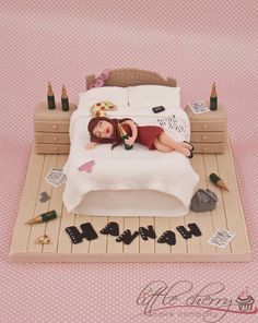 a cake that is shaped like a woman laying on a bed