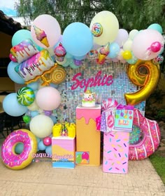 a birthday party with balloons, gifts and decorations