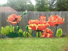 an image of flowers painted on the side of a fence