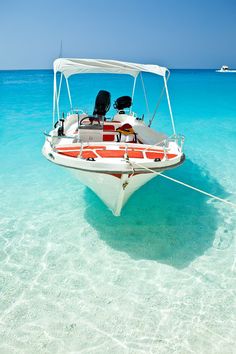 a small boat in the clear blue water