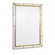 a gold framed mirror on a white wall