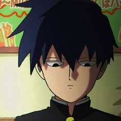 an anime character with black hair and blue eyes looking at something in front of him