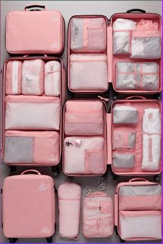 several pieces of pink luggage stacked on top of each other with white and gray items in them