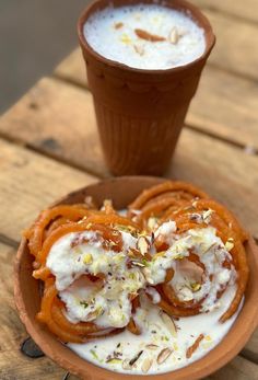 some food is sitting on a plate and next to a cup with something in it