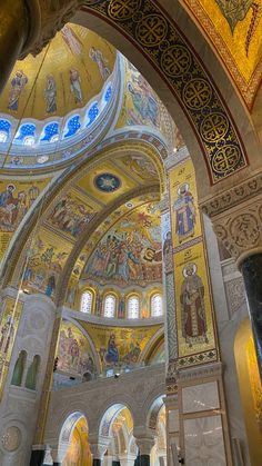 the inside of a church with many paintings on it