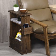 a wooden chair with a leather seat next to a book shelf and a phone holder