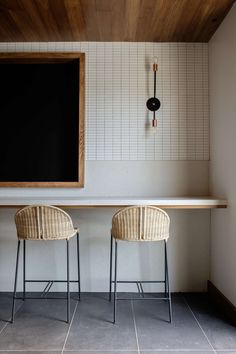 two chairs sitting next to each other near a counter