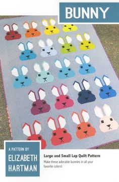 a quilt with many different colored bunnies on it