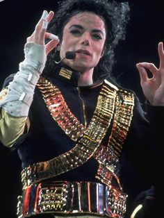 michael jackson performing on stage with his hands in the air