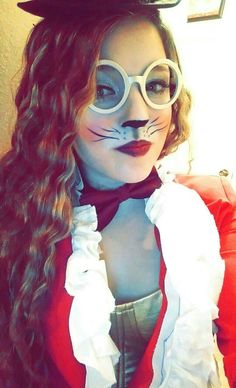 a woman with long hair and glasses wearing a cat costume