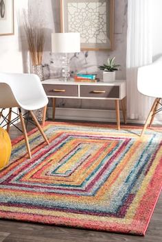 a multicolored area rug in a living room