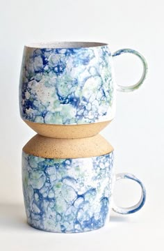 three coffee cups stacked on top of each other in blue and white marbled designs