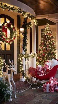 a house decorated for christmas with lots of presents on the front porch and trees in the yard