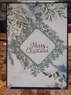 a merry christmas card is displayed on a table