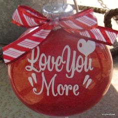 a red ornament with the words love you more on it