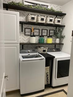 a washer and dryer in a small room with shelves above the washer