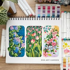 an open notebook with four different colored flowers on it next to crayons and markers