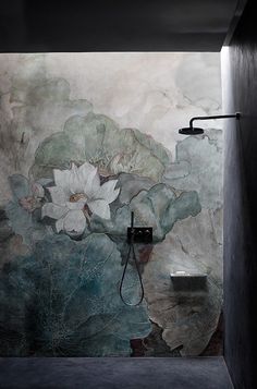 an artisticly designed bathroom with flowers painted on the wall